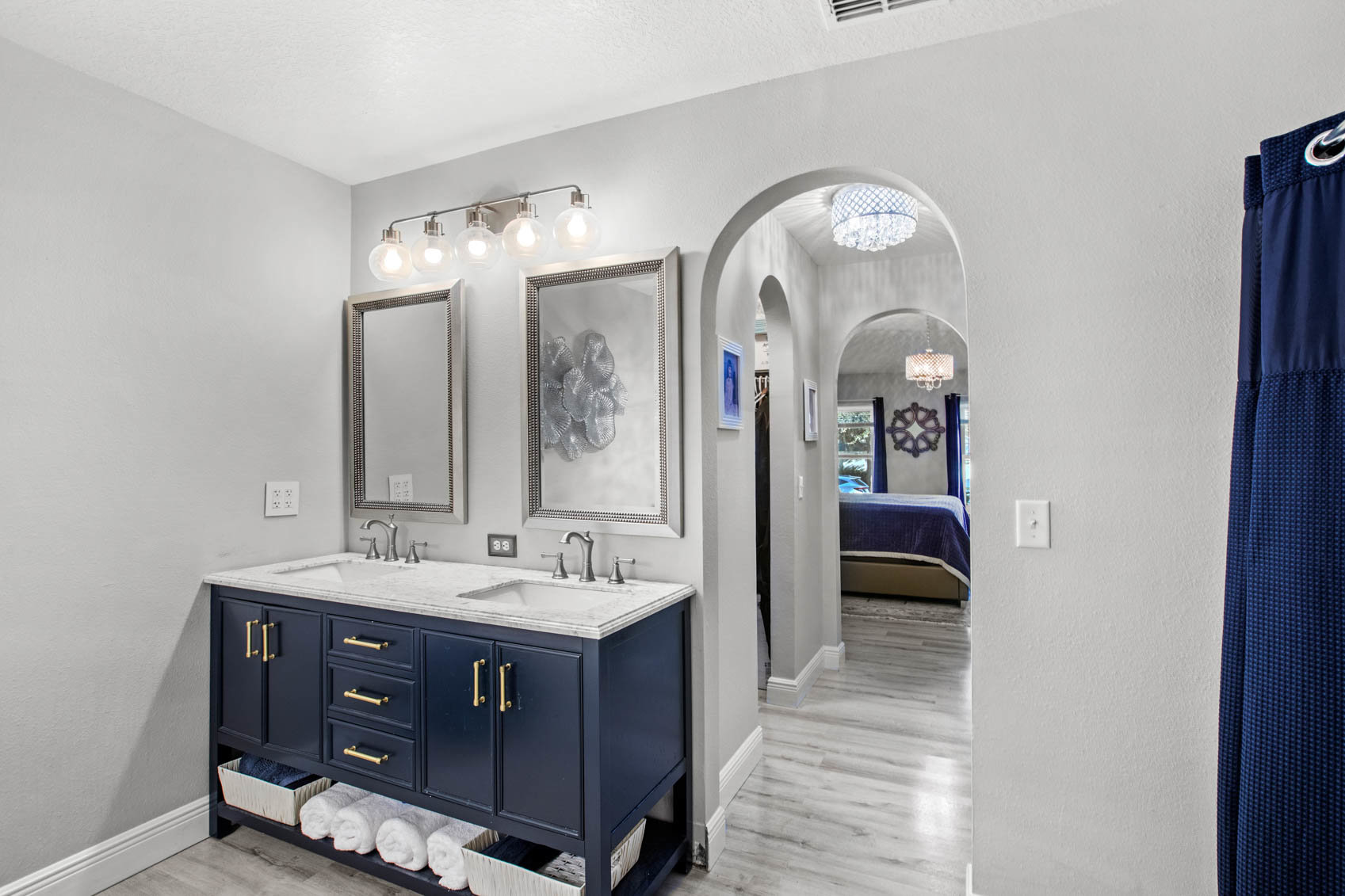 primary bathroom hallway with blue sink cabinet